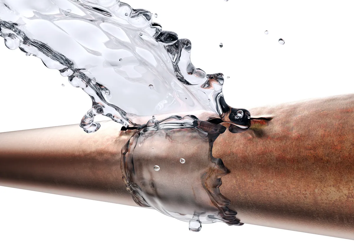 Water splashing from a corroded copper pipe, from our Laguna Beach guide: Plumbing Inspection Before Buying a House