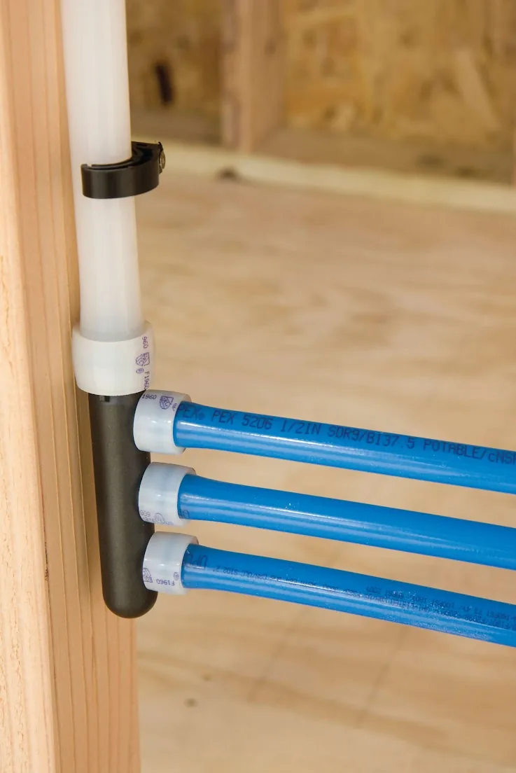 Blue PEX lines leaving a manifold fastened to a wall stud – Laguna Beach Navien Tankless Water Heater Installation for Laguna Beach, CA homes